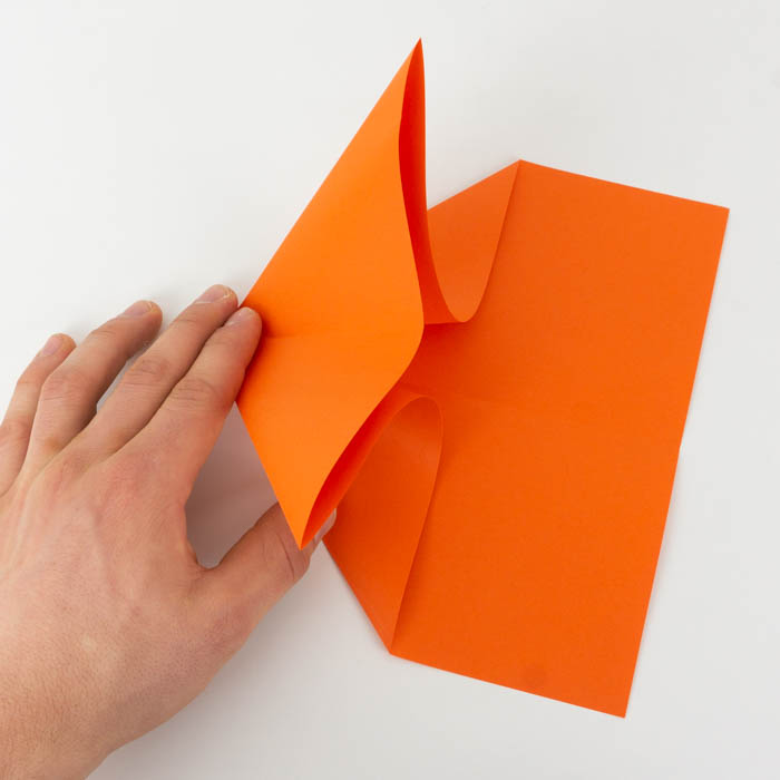 Fold the tip of the paper plane